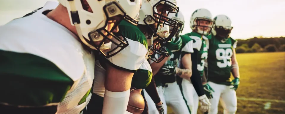 A group of high school athletes working together, demonstrating leadership skills on and off the field.