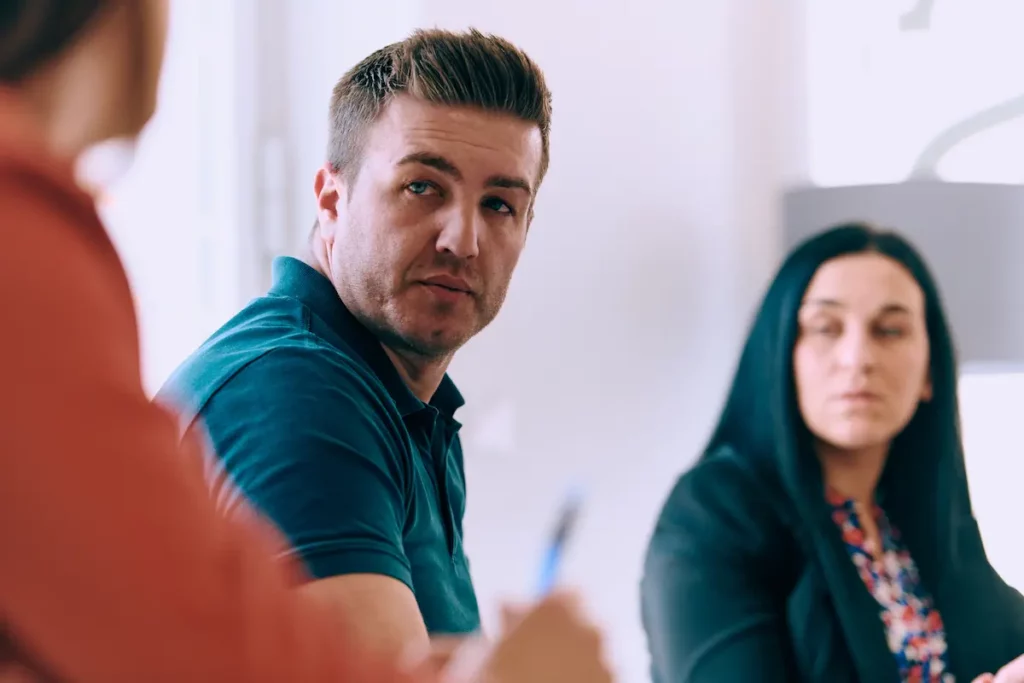 Athletic man highly focused and engaged in a meeting to build athletic program relationships