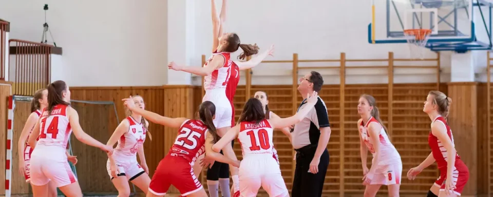 Two basketball teams competing against each other.