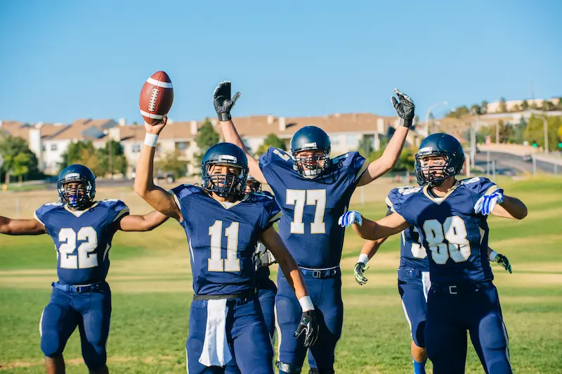 A team of high school football players plays for fun. 