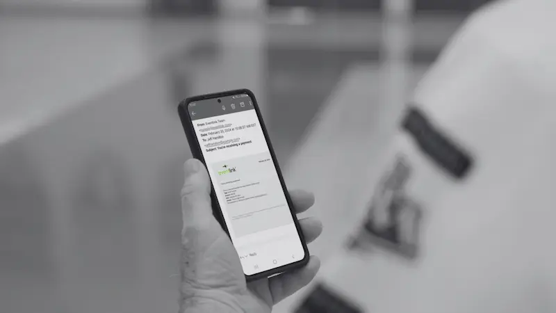 Man using Eventlink® app to download a ticket.  