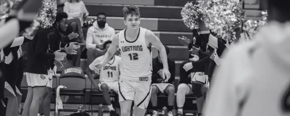 Young man runs out to the court for a basketball game.