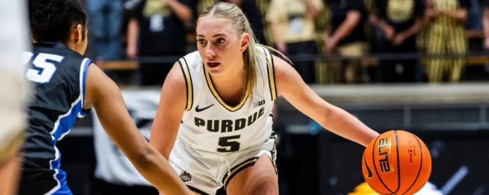 Purdue Women’s Basketball player, Taylor Feldman, dribbling a basketball during a game.